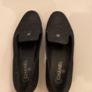 Black shinny Chanel slip on’s